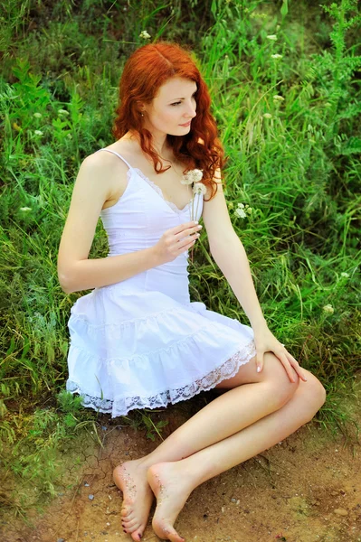 Cute redhead woman with dandelions. — Stock Photo, Image