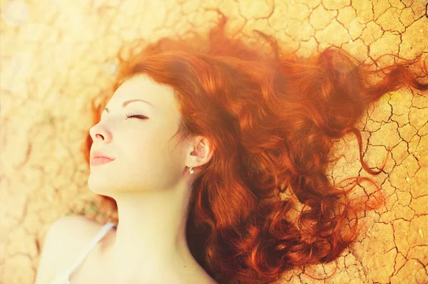 Beautiful young woman portrait with long curly red hair. — Stock Photo, Image