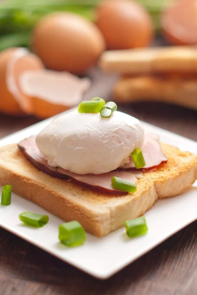 Läcker frukost. ägg benedict med skinka på toast. — Stockfoto