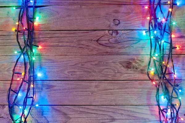 Natal luz fundo sobre tábuas de madeira — Fotografia de Stock