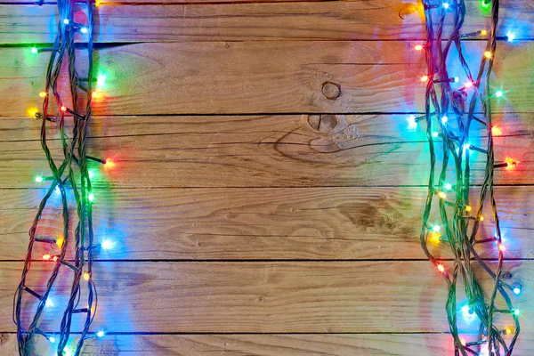 Natal luz fundo sobre tábuas de madeira — Fotografia de Stock
