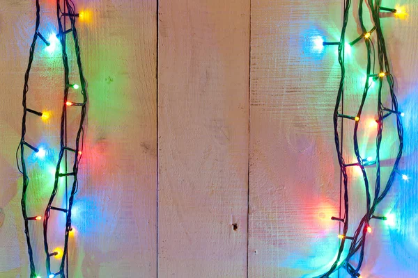 Natal luz fundo sobre tábuas de madeira — Fotografia de Stock