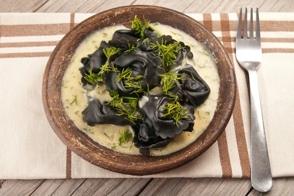 Black ravioli stuffed salmon with dill mustard sauce — Stock Photo, Image