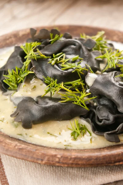 Black ravioli stuffed salmon with dill mustard sauce — Stock Photo, Image