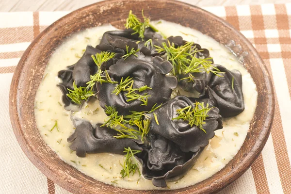 Black ravioli stuffed salmon with dill mustard sauce — Stock Photo, Image
