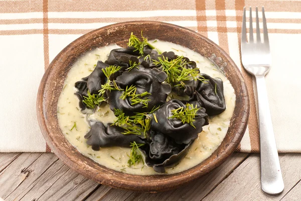 Black ravioli stuffed salmon with dill mustard sauce — Stock Photo, Image