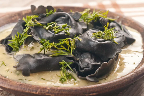 Black ravioli stuffed salmon with dill mustard sauce — Stock Photo, Image