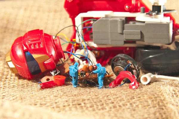 Two people checking broken toy. The concept technology