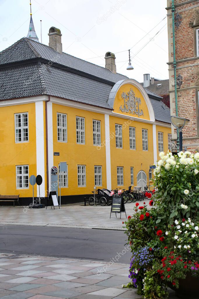 Old City Town Hall. Beautiful historic yellow and white painted building in the city center, Aalborg, Denmark. 