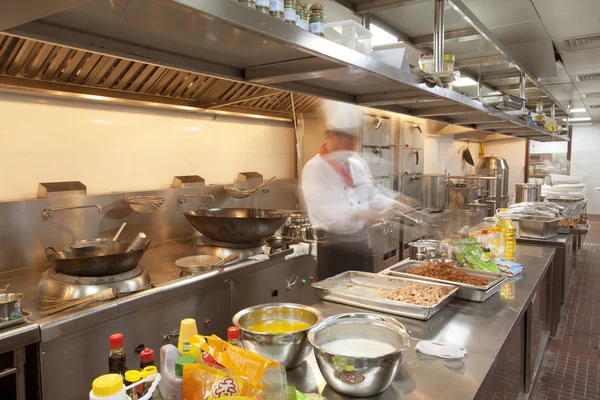 Chef cooking at commercial kitchen - hot job! — Stock Photo, Image