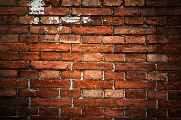 Fundo de tijolo vermelho: close-up de uma antiga parede de tijolo desigual . Fotografia De Stock