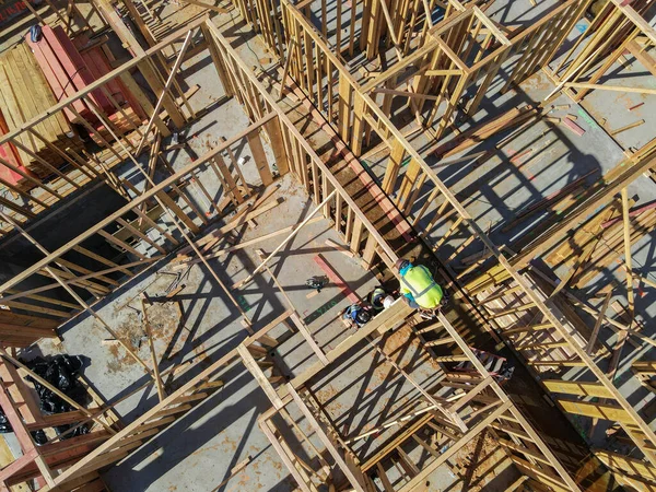 Aerial view of a new building being framed by carpenters. — Stock Photo, Image