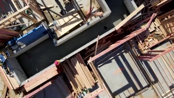 Aerial view of a new building being framed by carpenters. — Stock Video