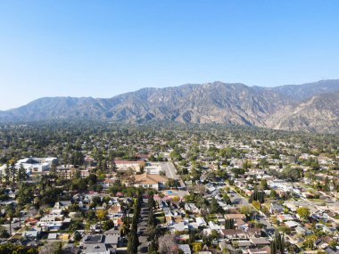 Aerial view above Pasadena neighborhood with mountain on the background. California clipart