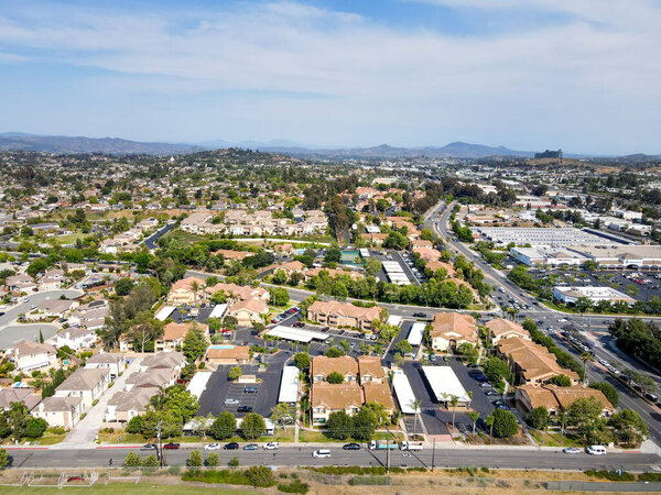Aerial view of San Marcos neighborhood with houses and street during sunny day, California, USA.
