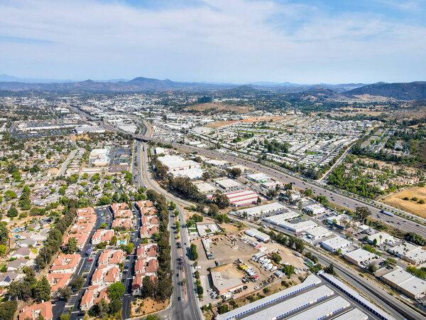 Aerial view of San Marcos neighborhood with houses and street during sunny day, California, USA.
