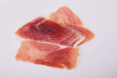Jamon, Prosciutto, Speck, Dry Cured Meat or Ham slices on white background. Studio shot