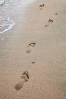 Foot prints on the beach of a seashore near the sea