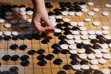 Go game or Weiqi (Wei-chi) - traditional Chinese board game. Shallow depth of field