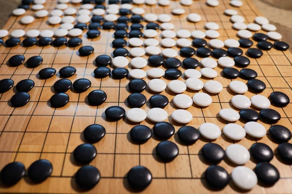 Go game or Weiqi (Wei-chi) - traditional Chinese board game. Shallow depth of field