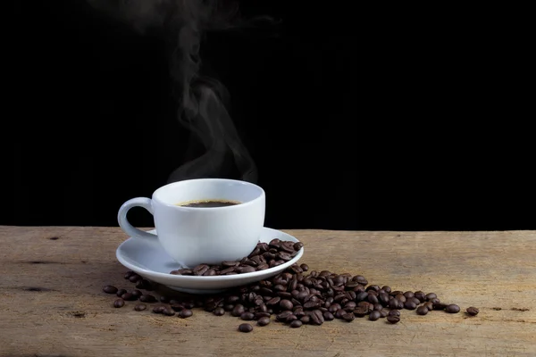 Taza de café sobre fondo de madera viejo — Foto de Stock