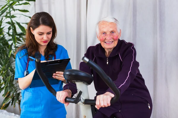 Geriatrician het maken van notities over de capaciteit van de inspanning — Stockfoto