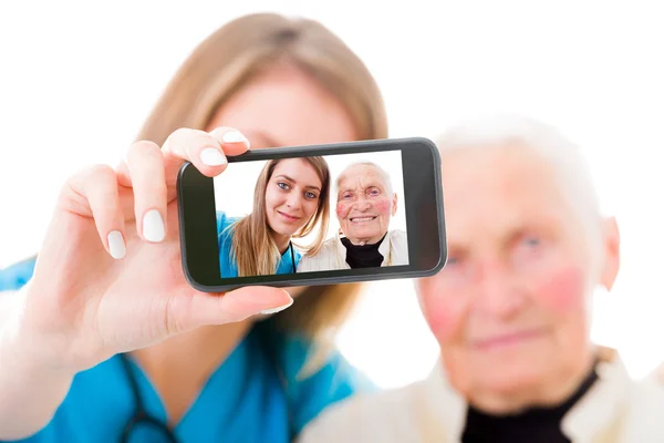 Senior patient and young doctor self portrait — Stock Photo, Image