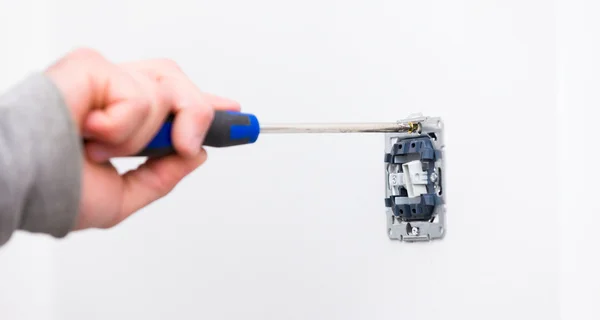 Electrician using tools for installing light — Stock Photo, Image