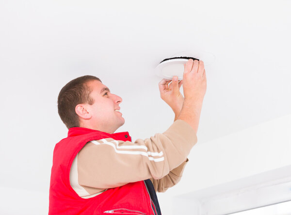 Electrician working with cords on wall