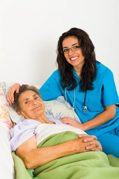 Verpleegkundige zorg voor zieke oudere dame — Stockfoto