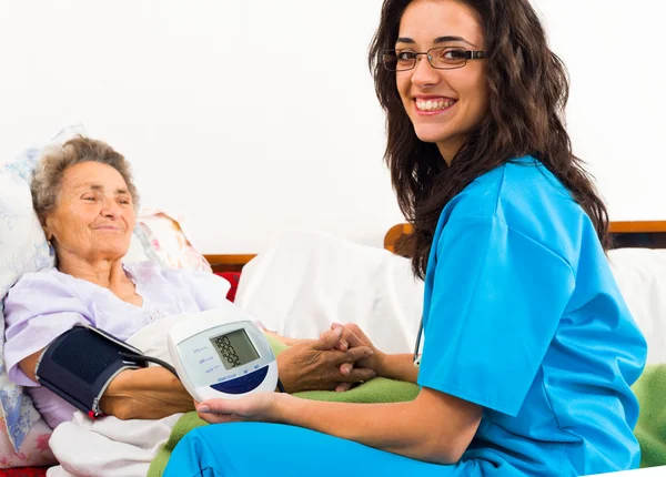 Nurse using digital blood pressure — Stock Photo, Image
