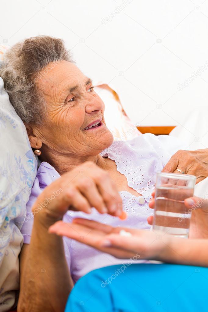 Elderly woman Taking Pills