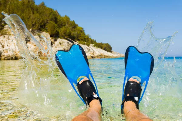 Man splashing with his lags equipped with snorkeling flippers — Stock Photo, Image