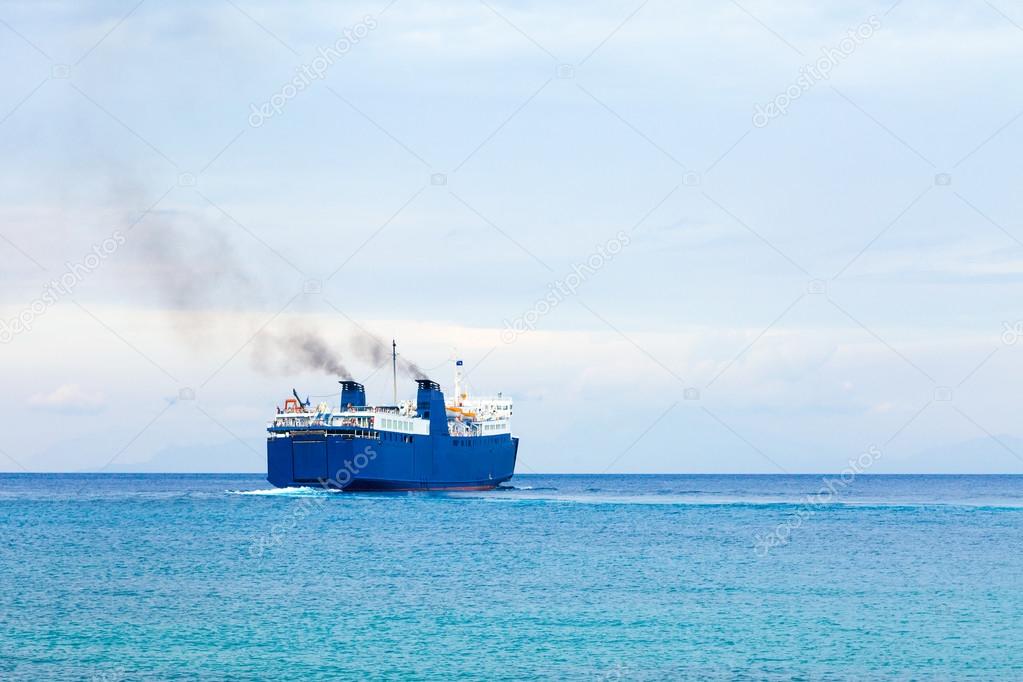 Big cargo ship and ferry boat in the turquoise waters