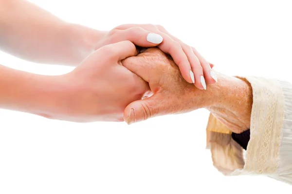 Oudere handen gehouden door een jonge persoon — Stockfoto