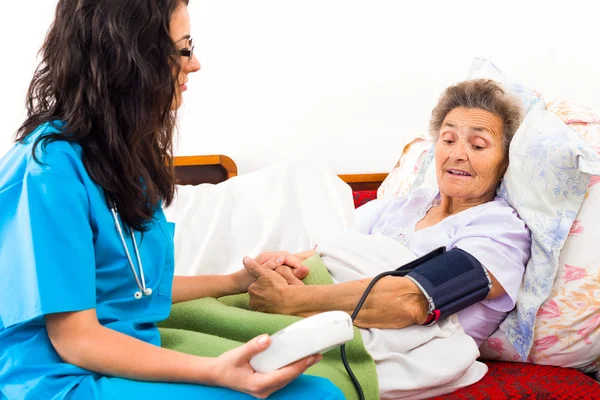 Nurse using digital blood pressure measure — Stock Photo, Image