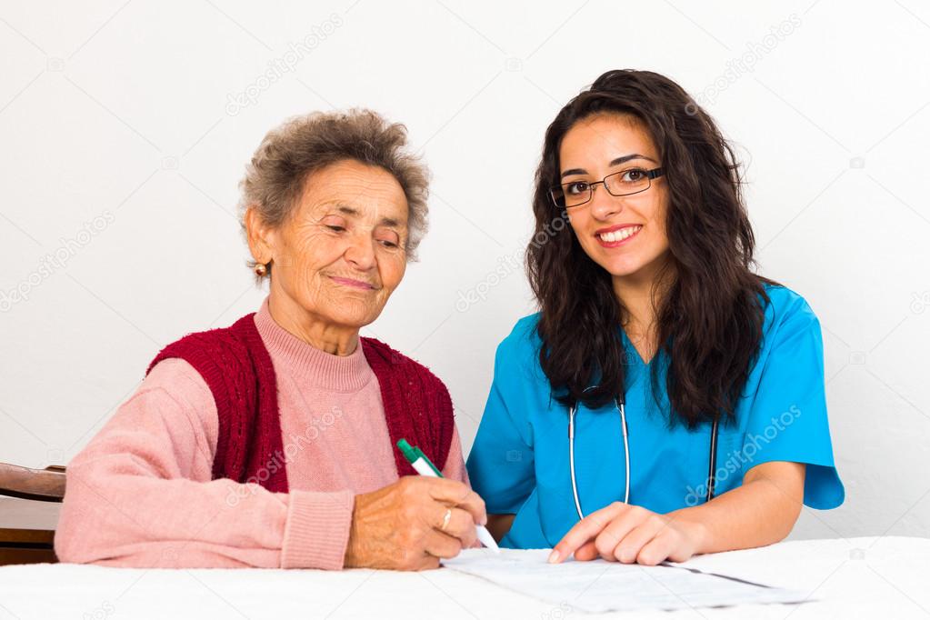 Nurse Helping Elderly Register for Nursing Home