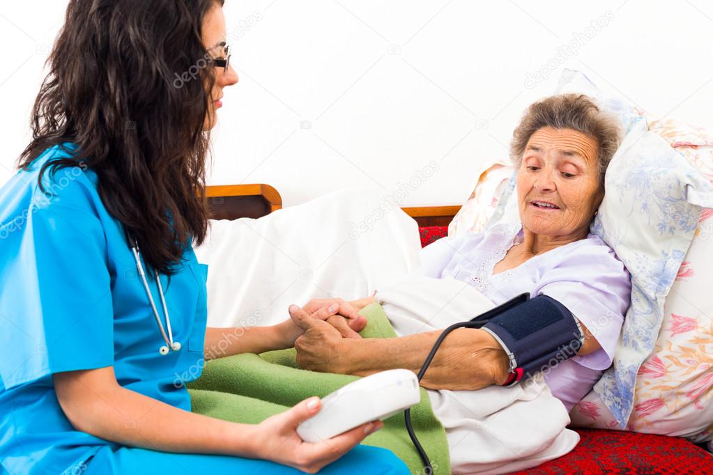 nurse using digital blood pressure measure