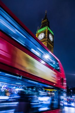 british bus passing  in front of Big Ben.