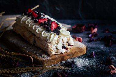 Meringue roll with berries. Delicious meringue roll on the table 