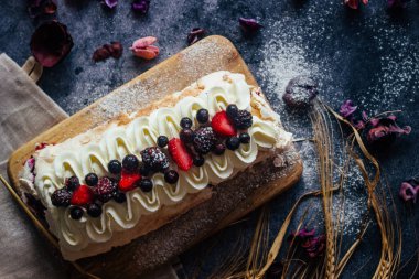 Meringue roll with berries. Delicious meringue roll on the table 