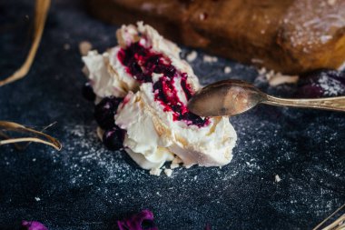 Meringue roll with berries. Delicious meringue roll on the table 
