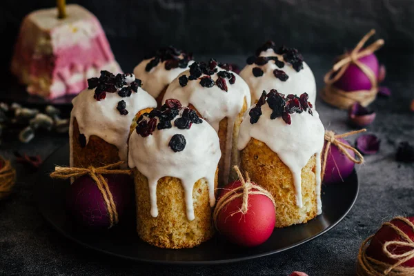 Easter cakes. A traditional Orthodox dish for Easter. Easter cakes with dried apricots, raisins and icing. Easter composition with painted eggs