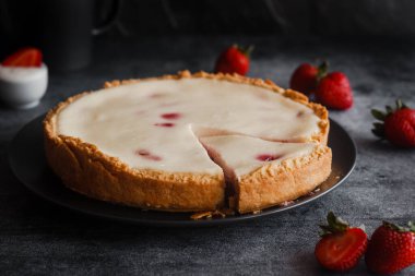 Delicious pie with strawberries and cream. Pie on the table. Pie with berries on a plate