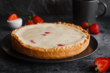 Delicious pie with strawberries and cream. Pie on the table. Pie with berries on a plate