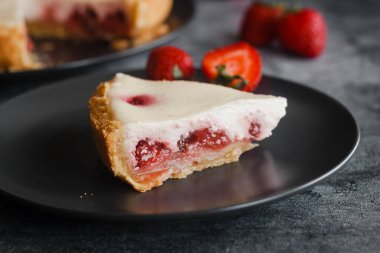Delicious pie with strawberries and cream. Pie on the table. Pie with berries on a plate