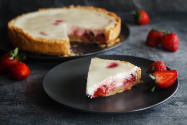 Delicious pie with strawberries and cream. Pie on the table. Pie with berries on a plate