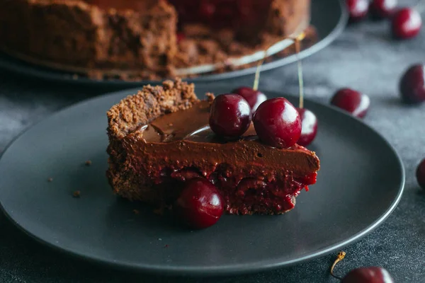 Pie with chocolate and cherries. Delicious cake on a plate