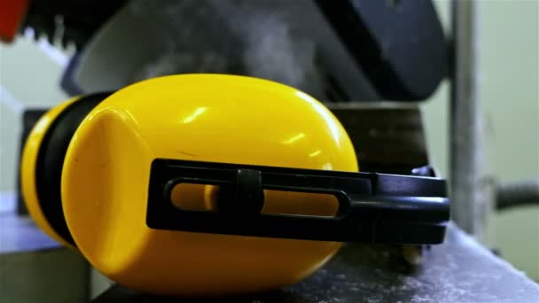Arbeiter-Kopfhörer, die an einer Maschine zur Herstellung von PVC-Fenstern in einer Fabrik liegen, Dolly — Stockvideo