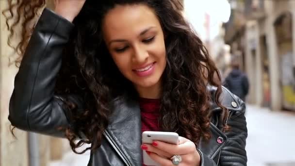 Portret van jonge vrouw met slimme telefoon wandelen in de straten van de stad, Slow Motion — Stockvideo